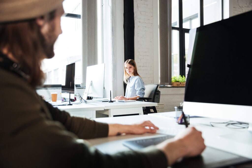 A man and woman working in a modern office space