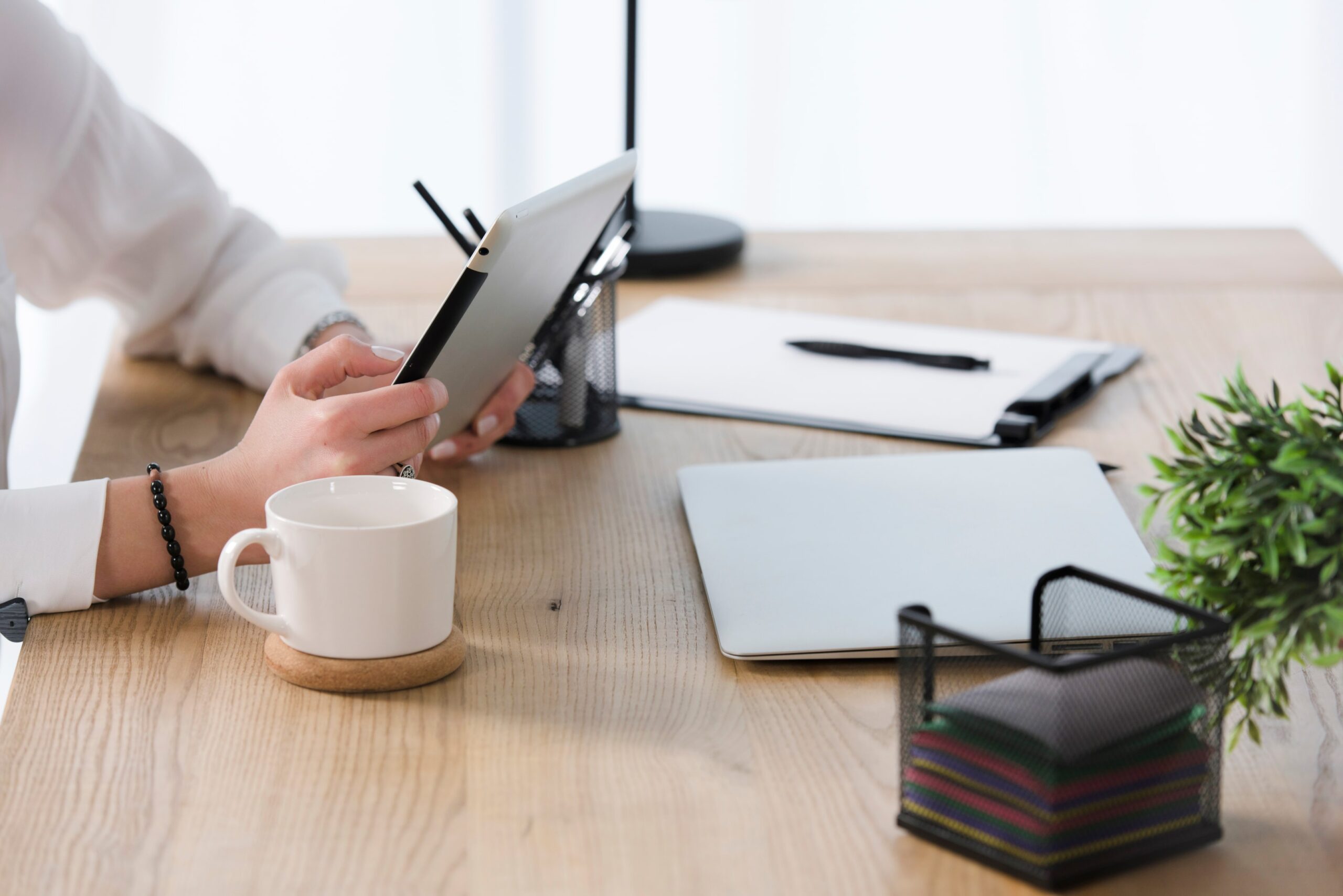 A person engaged with a laptop at a desk