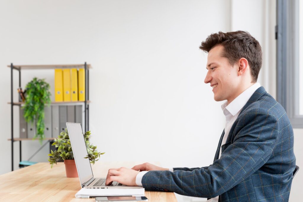 A man in front of a laptop