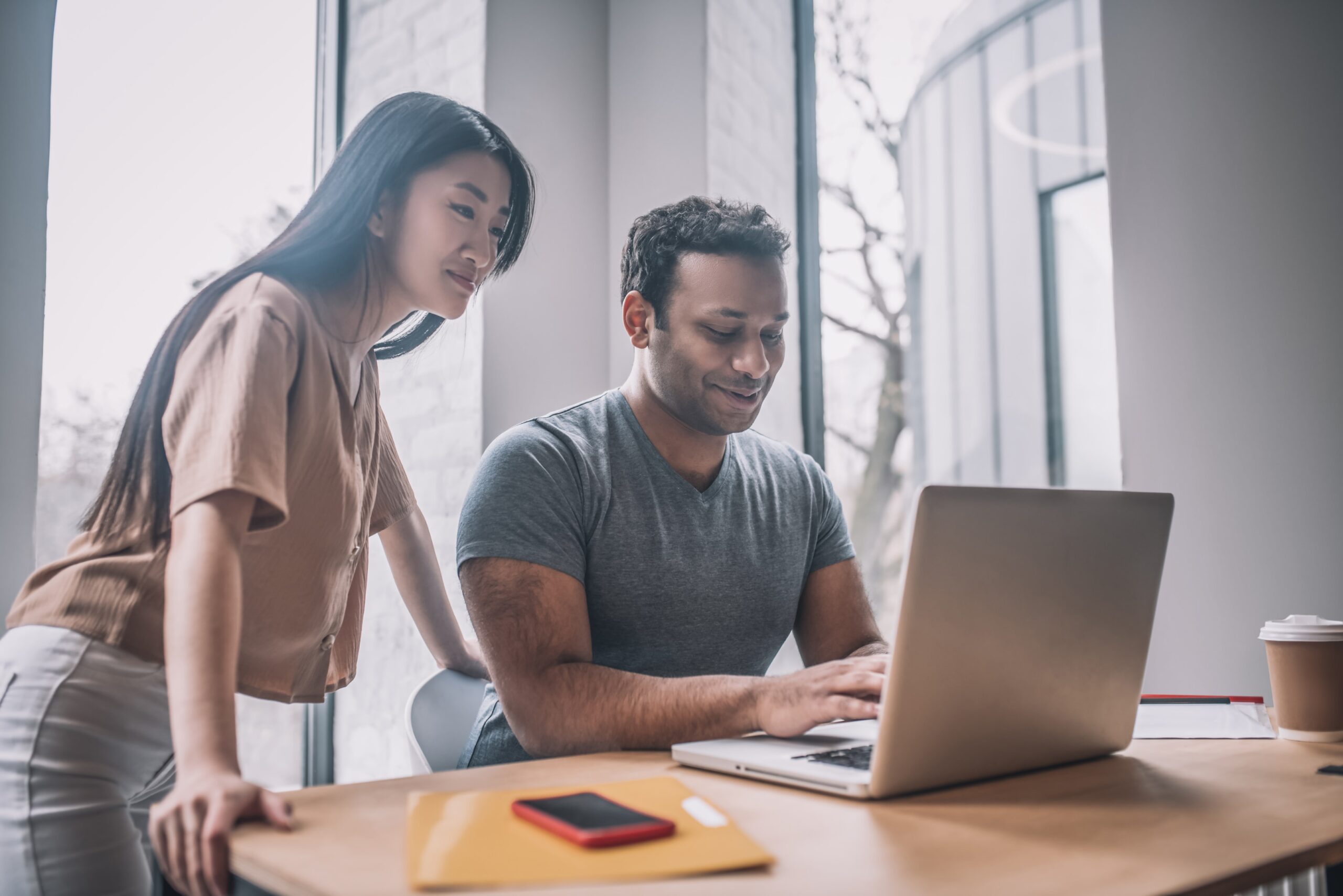 man and woman looking at the computer