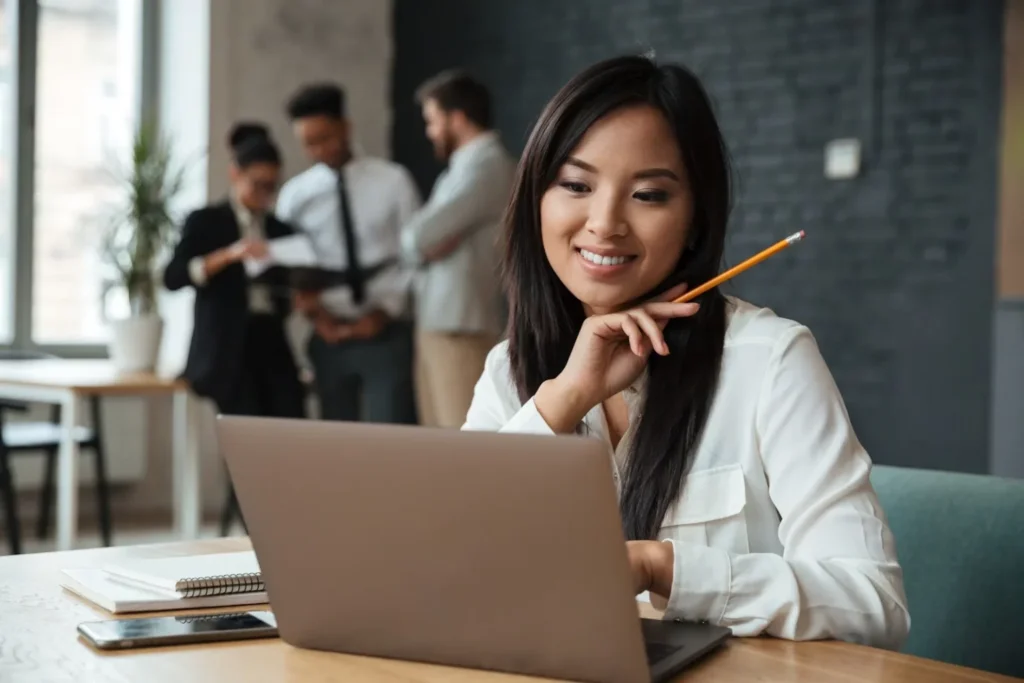 woman smiling holding a pencil